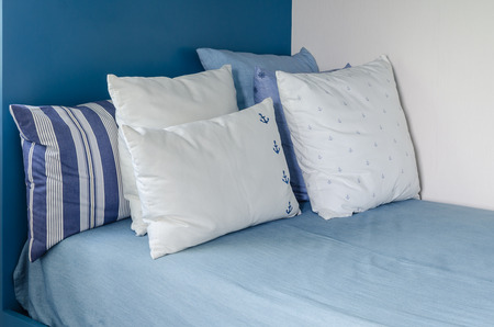 pillows on blue bed in kid bedroom at homeの写真素材
