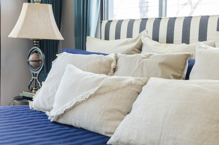 pillows on blue bed with lamp at homeの写真素材