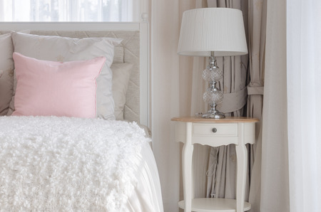 pink pillow on white luxury bed in bedroom at homeの写真素材