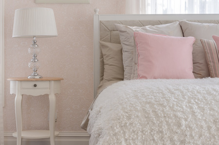 pink pillow on white luxury bed in bedroom at homeの写真素材
