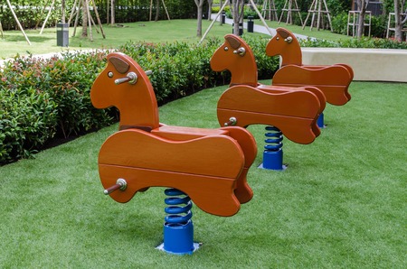playground area in park with wood hourseの写真素材