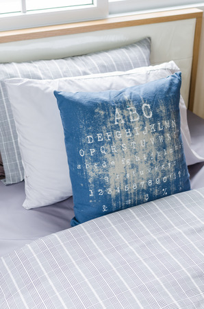 row of pillows in modern single bedroom at homeの写真素材