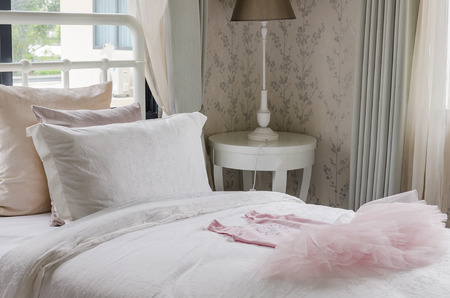 single bed with pink girl's dressの写真素材