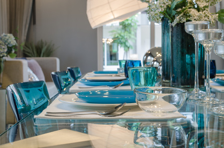 table set on glass table in dinning roomの写真素材