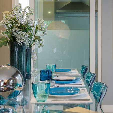 table set on modern glass dinning table at homeの写真素材