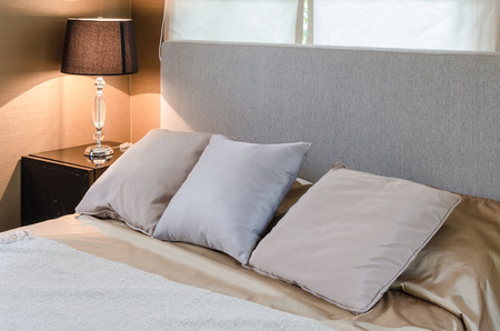 three pillows on bed in bedroom at homeの写真素材