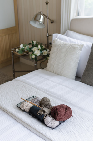 tray of crochet on bed in bedroomの写真素材