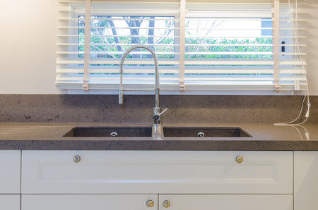 Water tap and sink in kitchenの写真素材