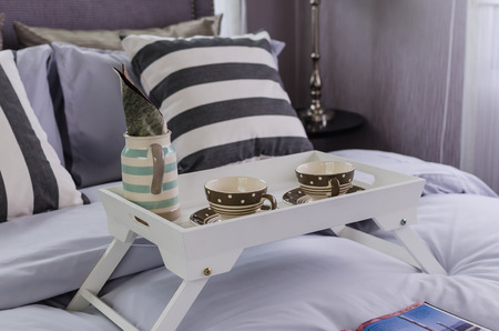 white tray of tea set on bed