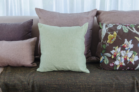 green pillow with blanket on sofa in living room at homeの写真素材