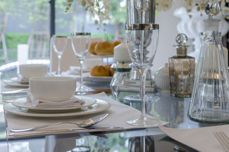 table set on glass table in dinning room at homeの写真素材