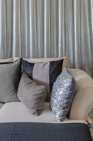 pillows on sofa with steel curtain as background at homeの写真素材