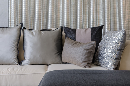 pillows on sofa with steel curtain as background at homeの写真素材
