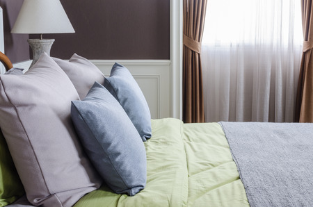 luxury bedroom with blue pillows on green bed at home