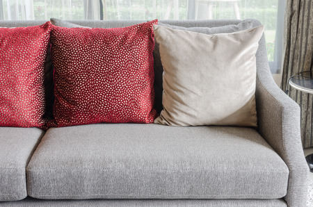 red pillows on sofa in living room at homeの写真素材