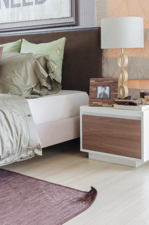modern white lamp on white table in bedroom at homeの写真素材
