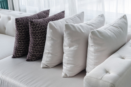 row of pillows on white modern sofa in living room at homeの写真素材