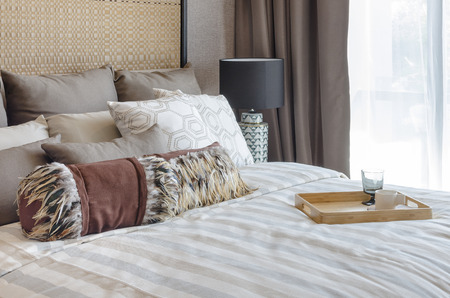 luxury bedroom with cup and glass on wooden tray at home