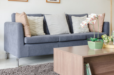 three of pillows on dark blue sofa in modern living room at homeの写真素材