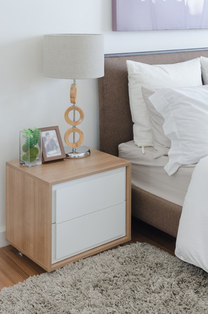 modern wooden lamp on table in bedroom at homeの写真素材