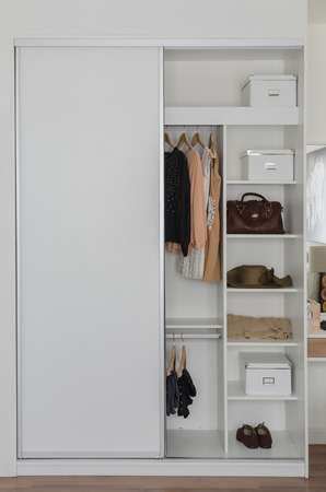 white closet with clothes and accessories at homeの写真素材