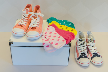 colorful socks on white paper box with two of sneakersの写真素材