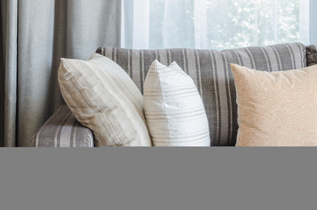 row of pillows on modern grey sofa in living roomの写真素材