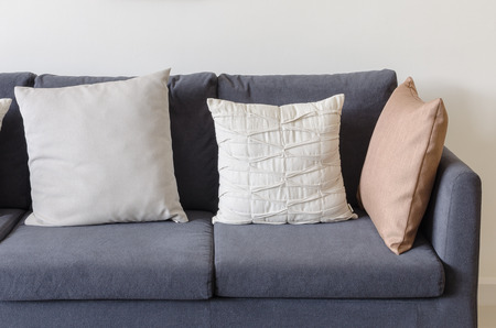 three of pillows on dark blue sofa in modern living roomの写真素材