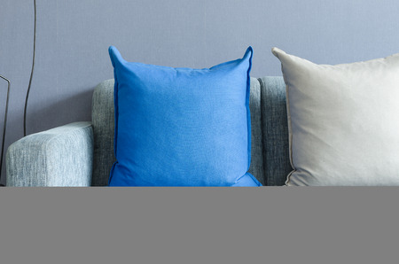 modern green sofa with blue and grey pillows in living roomの写真素材