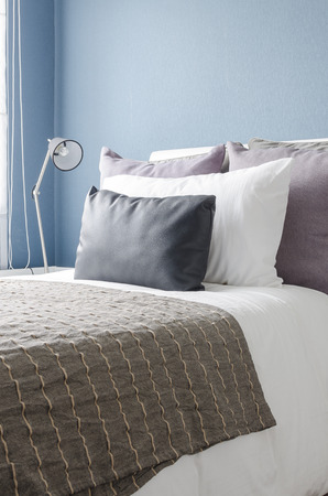 modern black lamp on white table in modern bedroom with blue wallの写真素材