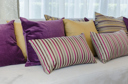 group of colorful pillows on sofa in living room at homeの写真素材