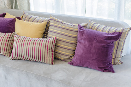 group of colorful pillows on sofa in living room at homeの写真素材