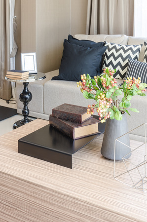 vase of flower with books on wooden table in living room at homeの写真素材
