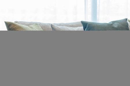 group of fabric pillows on fabric sofa in living room at homeの写真素材
