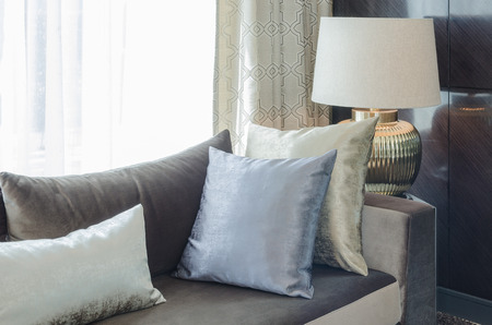 row of pillows on modern sofa in living room at homeの写真素材