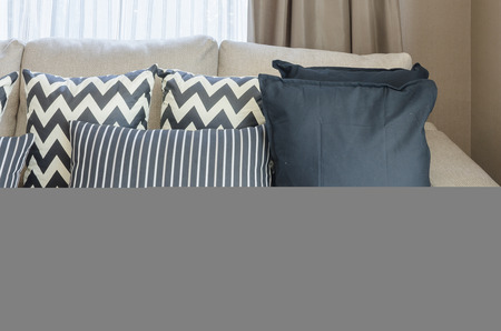 black and white pillows on beige color sofa in living roomの写真素材