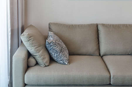 green fabric sofa with black and white pillow in living roomの写真素材