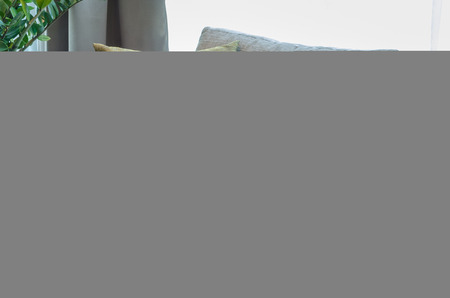 group of fabric pillows on fabric sofa in living room at homeの写真素材