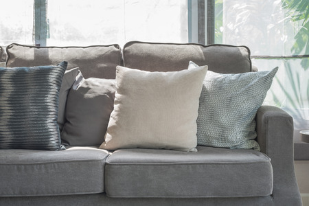 pillows on modern grey sofa in living room at homeの写真素材