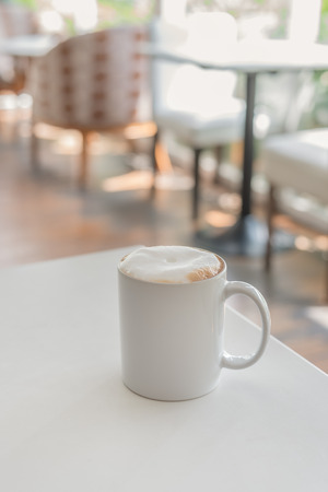 white coffee cup in coffee shop - vintage style effect pictureの写真素材