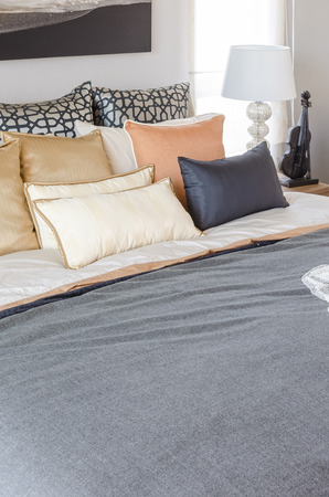 pillows on luxury bed with white lamp in bedroom at homeの写真素材
