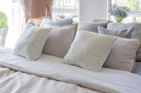 earth tone color pillows in luxury bedroom at homeの写真素材