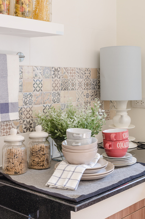 set of plates and dish on counter in kitchen room at homeの写真素材