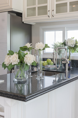 glass vase of flower on black granite counter in classic pantry roomの写真素材