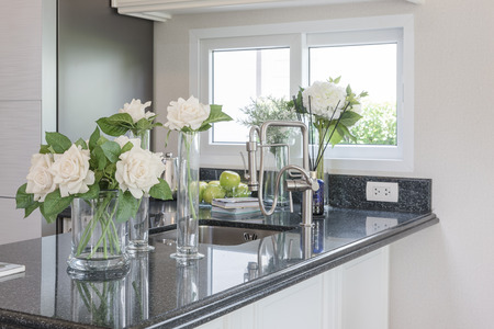 glass vase of flower on black granite counter in classic pantry roomの写真素材