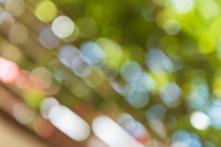 abstract blur of nature with bokhe of light through the trees and fences as background imageの写真素材