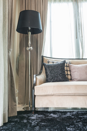 classic sofa style with pillows and black lamp in luxury living roomの写真素材