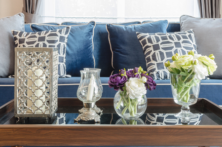 glass vase of flower on table in living room with blue classic sofa at homeの写真素材