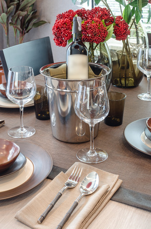 luxury table set on wooden dinning table with bottom of wineの写真素材