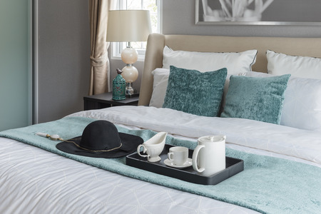 black hat on green blanket on bed in luxury bedroom at homeの写真素材